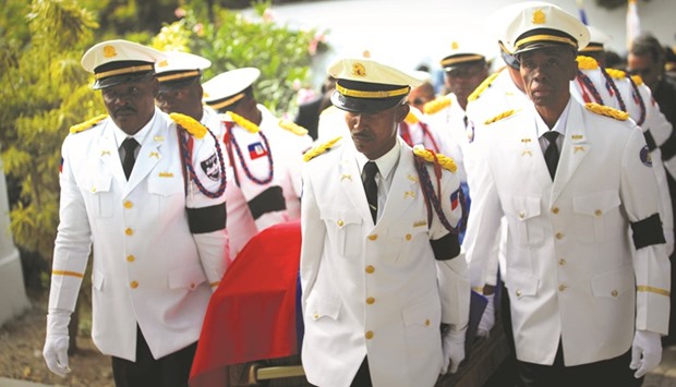 Members of the National Palace General Security Unit carry the coffin of former president Rene Preval at the vigil in Port-au-Prince on Friday.
