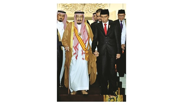Saudi Arabiau2019s King Salman (left) and Indonesiau2019s President Joko Widodo (right) holding hands after their meeting at the presidential palace in Bogor, West Java province, yesterday.