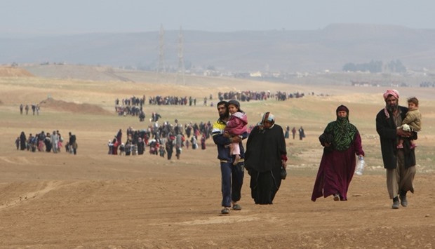 Iraqi displaced people flee their homes as Iraqi forces battle with Islamic State militants, in village of Badush northwest of Mosul.