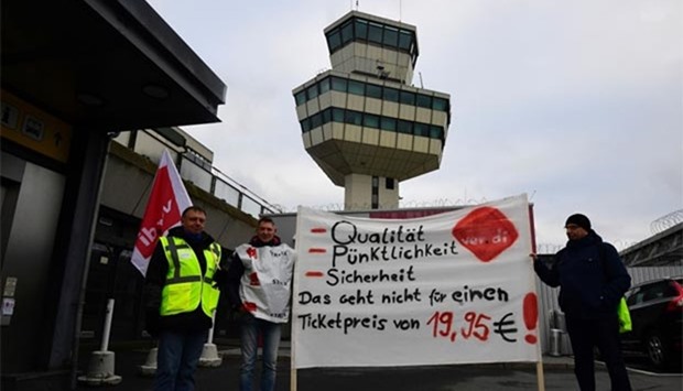Employees hold a banner reading during a wage strike of ground staff at Berlin's Tegel airport on Friday.
