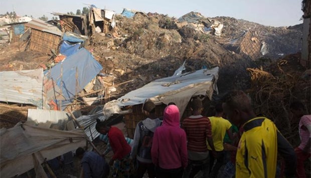 People look at the damage to dwellings near the main landfill of Addis Ababa on Sunday.
