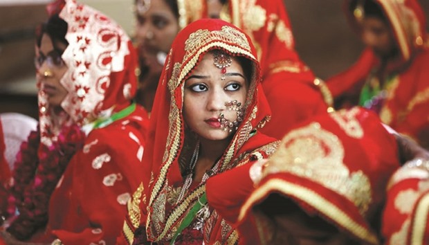 Brides sit and wait for their turn during a Muslim mass wedding in Ahmedabad, yesterday.