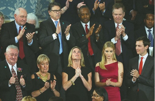 Carryn Owens, the wife of slain Navy SEAL William u2018Ryanu2019 Owens, looks up while being acknowledged by President Donald Trump during his address to a joint session of Congress in Washington, DC.