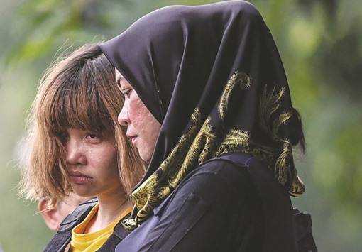 Vietnamese national Doan Thi Huong (left) is escorted after a court appearance in Sepang, Malaysia.