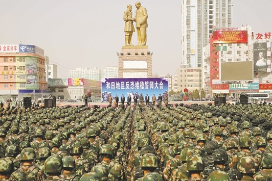 Chinese military police attending an anti-terrorist oath-taking rally in Hetian, Xinjiang.