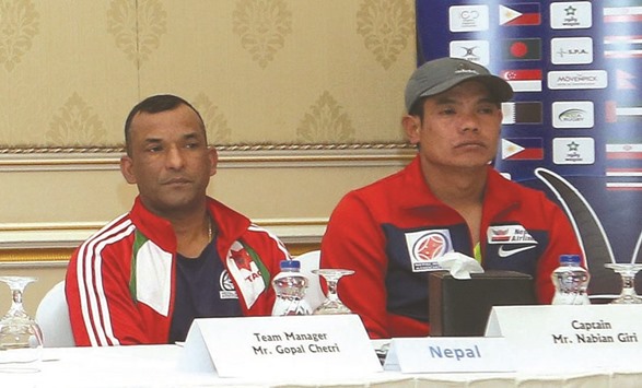 Nepal team manager Gopal Chhetri (left) and coach Hari Tamang attend a press conference in Doha yesterday.