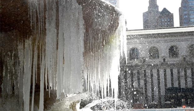 The Josephine Shaw Lowell Memorial Fountain in Bryant Park in New York is covered in ice on Monday as the weather continues to be below freezing.