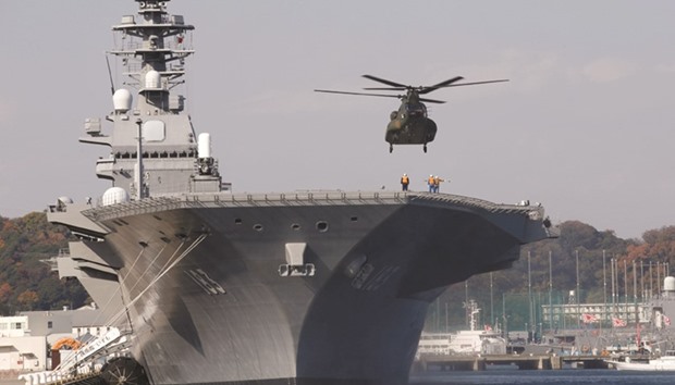 In this file picture, a helicopter lands on the Izumo, Japan Maritime Self Defence Forceu2019s (JMSDF) carrier, at Yokosuka base, south of Tokyo, Japan.