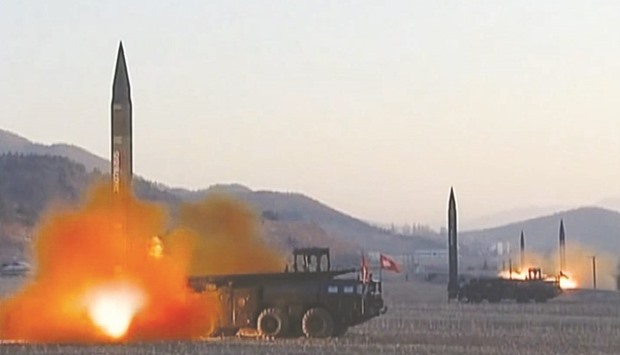 Ballistic missiles being launched during a military drill from an undisclosed location in North Korea.