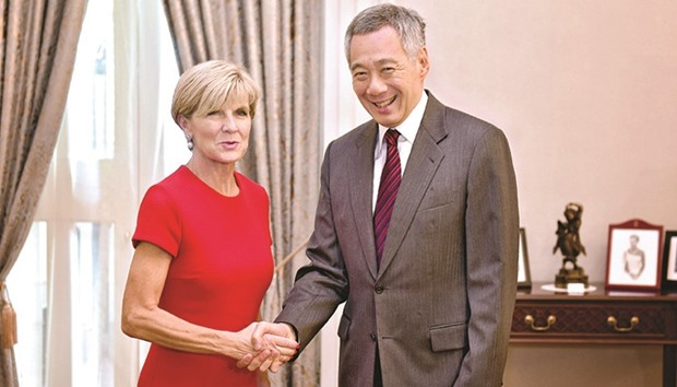 Australiau2019s Foreign Minister Julie Bishop shakes hands with Singaporeu2019s Prime Minister Lee Hsien-loong at the Istana, the official residence and office of the President of Singapore.