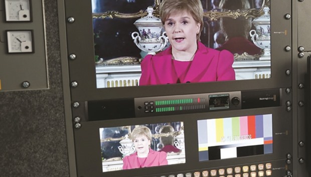 Scotlandu2019s First Minister Nicola Sturgeon is seen on a TV screens as she demanded a new independence referendum outside Bute House in Edinburgh yesterday.