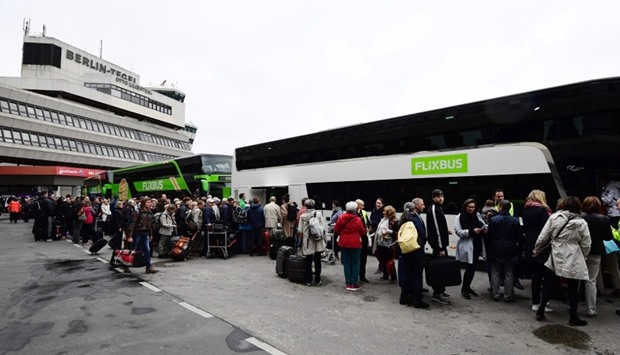 Passengers queue for bus transportation during a wage strike at Berlin's Tegel airport