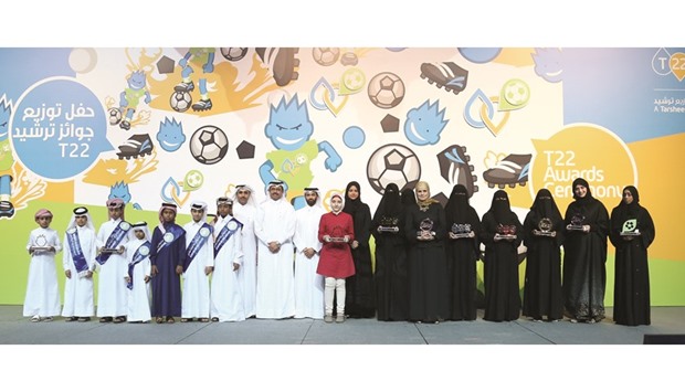 HE the Minister of Energy and Industry Dr Mohamed bin Saleh al-Sada, Kahramaa president Issa bin Hilal al-Kuwari and Supreme Council for Delivery and Legacy secretary general Hassan al-Thawadi with the award winners of the Tarsheed 22 (T22) campaign yesterday. PICTURE: Jayan Orma