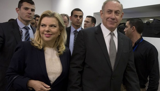 Israeli Prime Minister Benjamin Netanyahu and his wife Sara are seen as they enter the Tel Aviv magistrate court to give evidence in their libel case against a journalist.