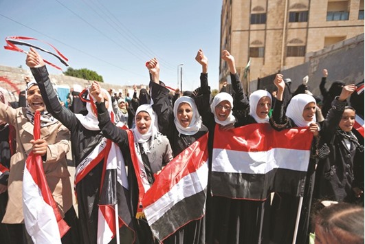Yemeni women shout slogans and wave their national flag during a sit-in yesterday, outside the United Nations (UN) offices in the capital, Sanaa.