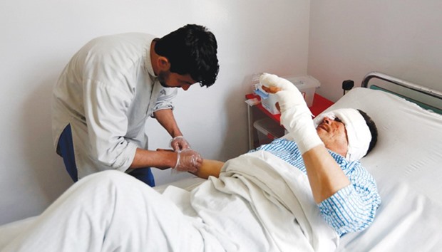 An injured man receives treatment at a hospital a day after a blast in Kabul yesterday.