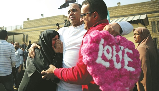 A released detainee hugs members of his family after Egyptian President Abdel Fattah al-Sisi issued a pardon for 203 youths jailed for taking part in demonstrations, in front of the main gate of Tora Prison in Tora yesterday.