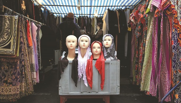 This file picture taken in east London shows people at a market stall selling the hijab.