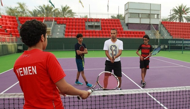 Suhail Alsaeedi from Sanaa, Ammar Saeed from Aden, Alhassan Ishaq from Sanaa and their coach Osama al-Maqaleh take part in a training session at Khalifa International Tennis and Squash Complex in Doha.