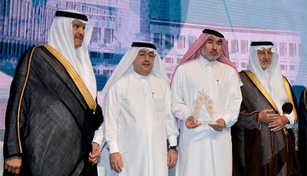 Msheireb's al-Mehshadi with the award as al-Jaidah and other officials look on.
