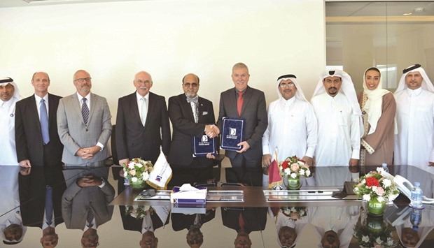 Doha Bank and CNA-Q officials after a sponsorship signing ceremony.
