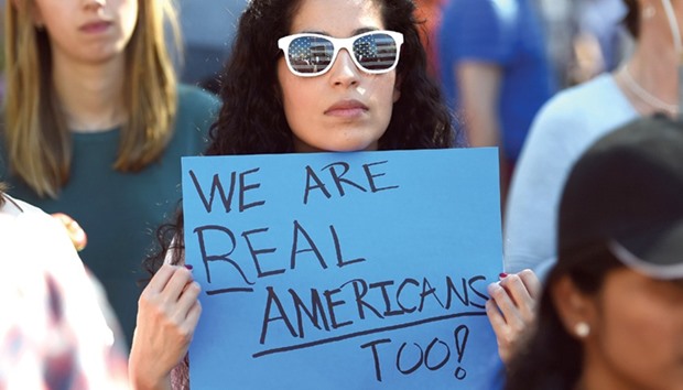 Tech employee Natalie Rios holds a sign during Tech Stands Up rally against President Donald Trump, in Palo Alto, California.