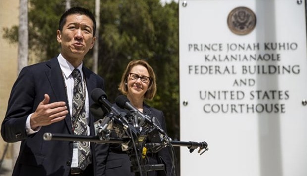 Hawaii State Attorney General Douglas Chin speaks as Oregon Attorney General Ellen Rosenblum looks on at a press conference in Honolulu. Attorneys for the state of Hawaii filed a lawsuit to stop President Donald Trump's revised travel ban.