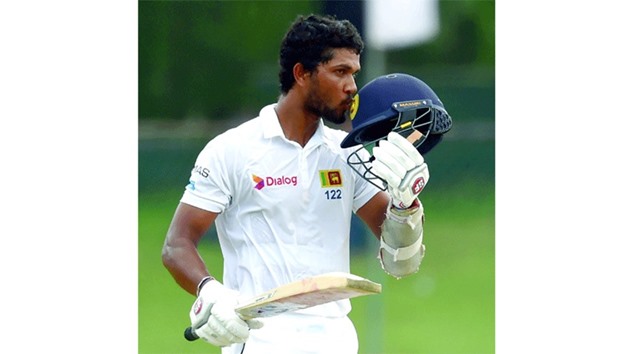 Sri Lankau2019s Dinesh Chandimal celebrates after scoring a century during the second day of the second and final Test against Bangladesh at the P. Sara Oval Cricket Stadium in Colombo. (AFP)
