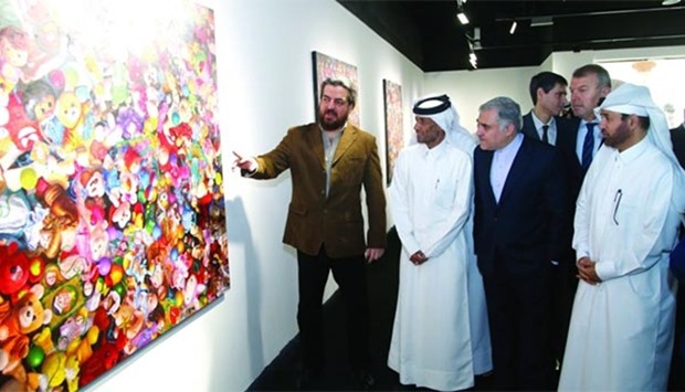 Iranian artist Siamak Azmi explains his works to Dr al-Sulaiti, dignitaries and other guests. PICTURES: Jayaram