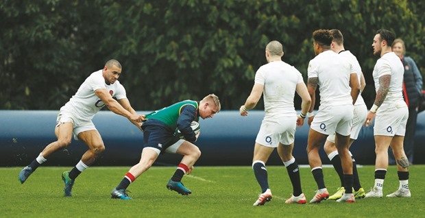 Englandu2019s Jonathan Joseph (L) practices a tackle during a team training session at Pennyhill Park in Bagshot, west of London. England are set to play Ireland in their final 6 Nations rugby union match in Dublin on Saturday. (AFP)