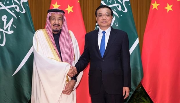 Chinese Premier Li Keqiang shakes hands with Saudi Arabia's King Salman at the Great Hall of the People in Beijing on Friday.