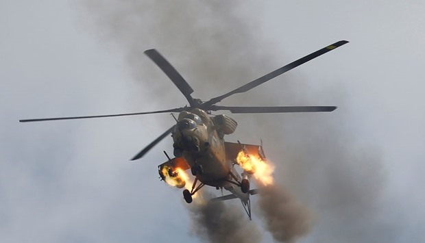 An Iraqi Air Force helicopter fires missiles against Islamic State militants during a battle in Mosul.