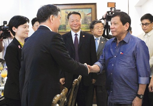 President Rodrigo Duterte greets Vice Premier of China, Wang Yang (left) during his courtesy call at the Presidential Guest House in Davao city.