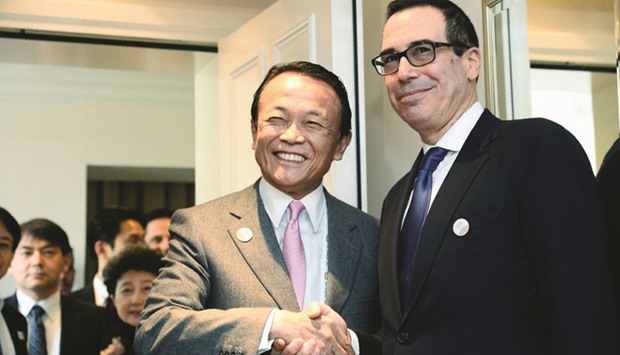 US Secretary of the Treasury Steven Mnuchin (right) shakes hands with Japanase Finance Minister Taro Aso prior bilateral talks during the G20 Finance Ministers and Central Bank Governors Meeting in Baden-Baden, southern Germany, yesterday. Mnuchin is being scrutinised by Washingtonu2019s key trading partners for clues on whether the worldu2019s biggest economy fully intends to abandon its long-standing support of open markets and free trade.