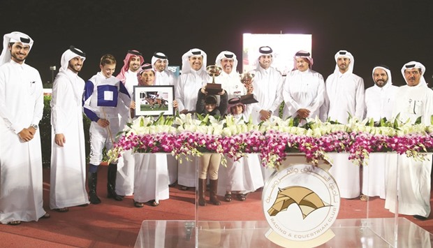 Qatar Racing and Equestrian Club vice chief steward Abdulla Rashid al-Kubaisi with the winners of The Late Yousef Al Romaihi Cup after Altarsheed won the 3200m feature on Thursday.