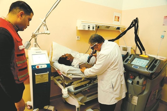 A doctor examines a patient at a facility provided by QRCS.