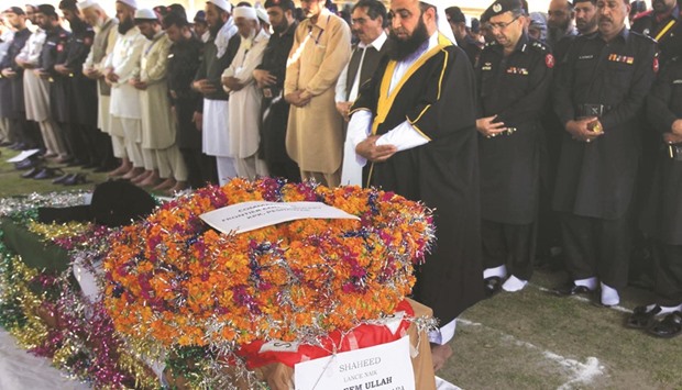 Pakistani security personnel of Frontier Constabulary (FC) offer funeral prayers for a colleague who was killed in a militant attack during his funeral in Peshawar yesterday.