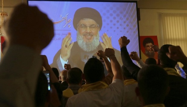 Lebanon's Hezbollah leader Sayyed Hassan Nasrallah addresses his supporters from a screen during a rally to commemorate Hezbollah Wounded Veterans Day in Beirut's southern suburbs, Lebanon, May 12, 2016.