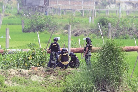 A Bangladeshi police bomb disposal unit tries to defuse explosives recovered from a foiled attacker in Dhaka yesterday.