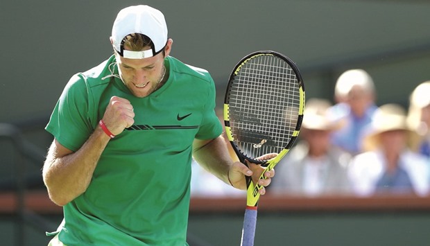 Jack Sock celebrates a point against Kei Nishikori of Japan.