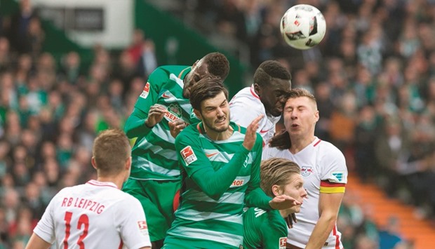 Leipzig players vie for the ball during the Bundesliga football match against Werder Bremen in Bremen yesterday. Bremen won 3-0.