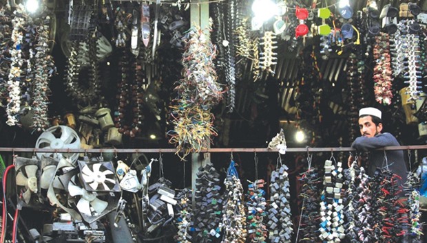 A man looks out from his shop at an automobile spare parts market in Rawalpindi, Pakistan.