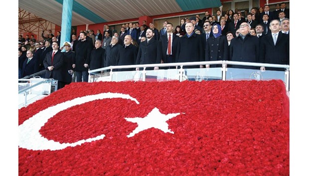 This picture provided by the Turkish Presidential Press Service yesterday shows Erdogan with Family Minister Fatma Betul Sayan Kaya, Culture and Tourism Minister Nabi Avci (second right), Minister of Energy and Natural Resources Berat Albayrak (sixth right) and Youth and Sports Minister Akif Cagatay Kilic (right) standing in silence during a ceremony marking the 102nd anniversary of the Canakkale Victory at 18 March Stadium in Canakkale, western Turkey.