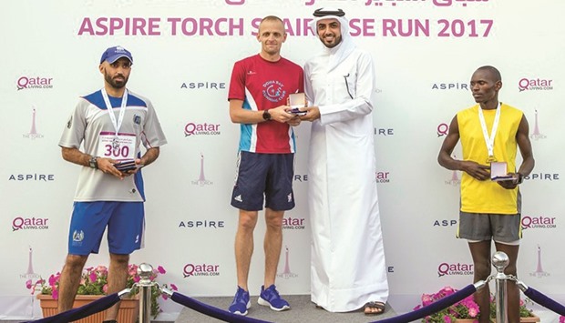 Nasser Abdulla al-Hajri, AZFu2019s director of PR and communications, with open category winner Andi Jones, runner-up Mohamed al-Obaidly and third-placed Hillary Rotich.