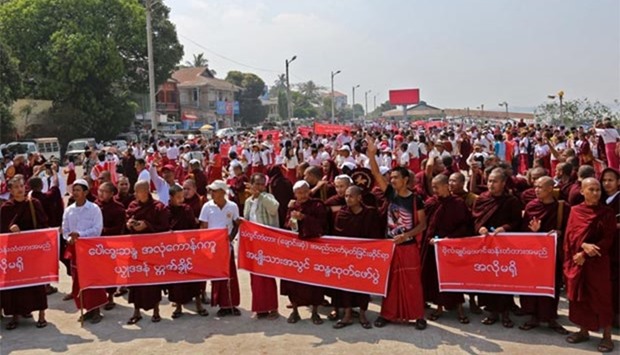 Monks and ethnic people shout slogans during a rally in Mawlamyine in Myanmar's Mon state on Sunday.