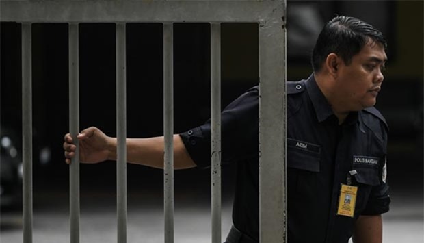 A Malaysian policeman closes the gate to the forensics wing of the Hospital Kuala Lumpur, where the body of Kim Jong-Nam is being held.
