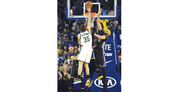 Mirza Teletovic of the Milwaukee Bucks is fouled by Stephen Curry (left) of the Golden State Warriors during the NBA game at Oracle in Oakland, California. on Saturday. (AFP)