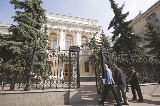 Visitors pass security to enter the headquarters of Russiau2019s central bank in Moscow. Bank of Russia has grown so focused on price growth that itu2019s making a resumption of foreign currency purchases for reserves conditional on meeting its inflation target, according to the head of its monetary policy department.