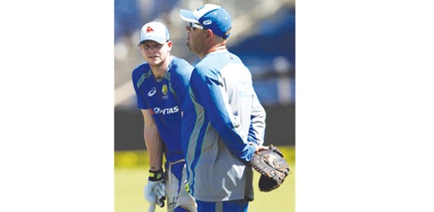 File picture of Australiau2019s captain Steve Smith (L) speaking to team coach Darren Lehmann.