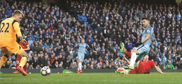 Manchester Cityu2019s Sergio Aguero scores a goal against Liverpool during a Premier League match at Etihad Stadium in Manchester yesterday. (Reuters)